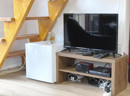 a living room with a television and a staircase at Vikendica Mihic in Zvornik