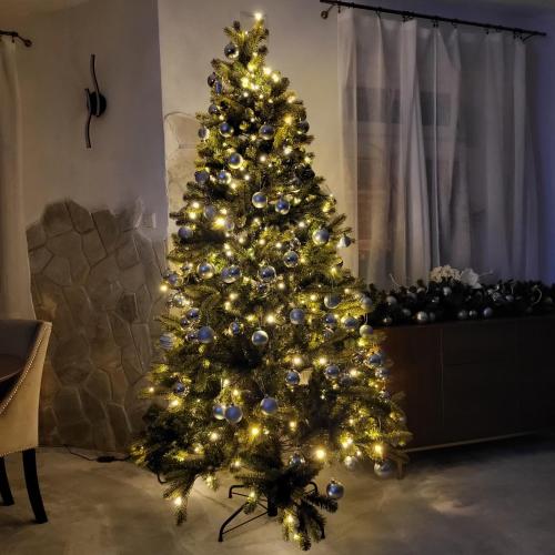 a christmas tree with lights in a living room at Apartment Villa Hřensko 132 in Hřensko