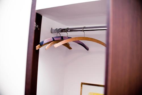 a group of three wooden hangers in a room at Studio Leena in Sibiu