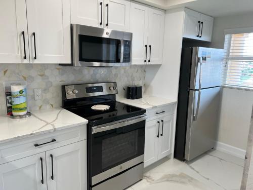 a kitchen with a black stove and a microwave at 5 minutes away from Disney, Westgate Resort in Orlando
