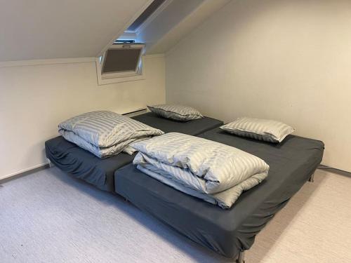 two twin beds in a room with at Lillehammer Guest House with common bath and kitchen in Lillehammer