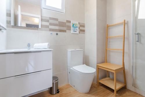 a bathroom with a toilet and a sink at Hostal El Perelló, Valencia in El Perelló