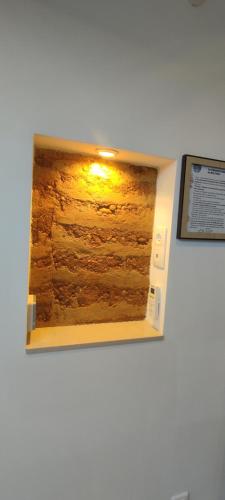 a window in a wall with a picture on it at Chambre d'hotes Mas Pékin in Mas-Thibert
