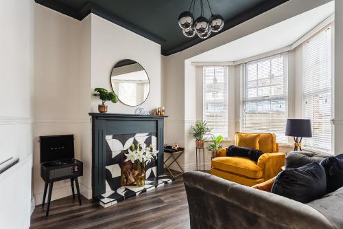 a living room with a couch and a fireplace at The Crescent Townhouse in Lisburn