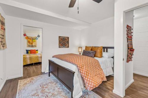 a bedroom with a bed with an orange comforter at Large Spanish Villa -Hot tub- Pool -Gym- Game Room in Sedona