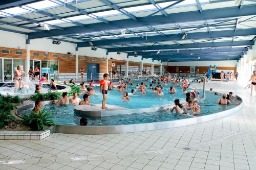 a large group of people in a swimming pool at Bel appartement en coeur de ville - 20 minutes du PAL in Moulins