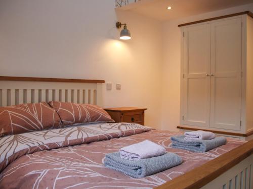 a bedroom with a bed with towels on it at Robins Nest - Uk40747 in Coddington