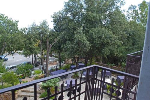a balcony view of a park with chairs and trees at Nascar Hotel in Santa Maria Navarrese