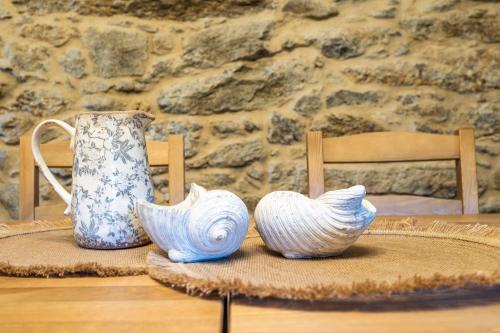 a table with a vase and two bowls on it at Casa Rural Laxido in Rianjo