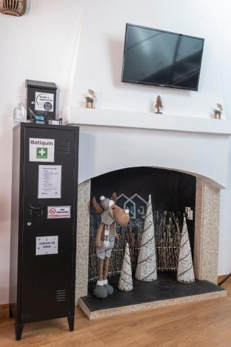 a fireplace with a tv above it with a toy at ANJ Alojamientos in Guadalupe