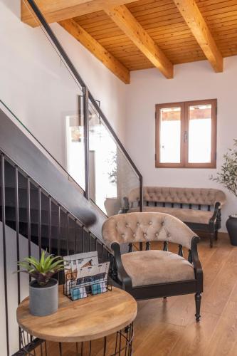 a living room with stairs with a bench and a table at ANJ Alojamientos in Guadalupe