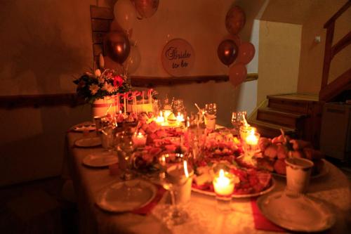 a table with candles and plates of food and balloons at Vikendica Čeperković #1 in Kopaonik