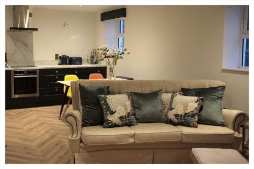 a living room with a couch with pillows on it at Killeavy Cottage in Meigh