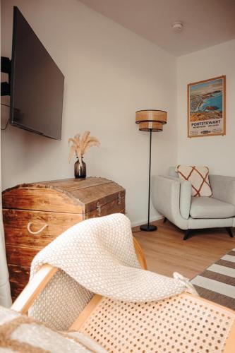 a living room with a television and a chair at The Cranny, Portstewart in Portstewart