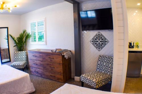 a bedroom with a bed and a dresser and a tv at Devon Shores in Clearwater Beach