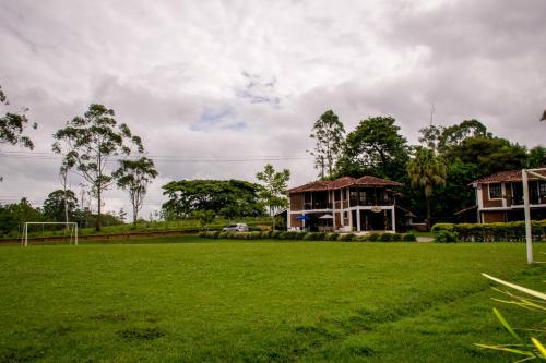 a soccer field in front of a house at Finca Hotel Casa Nostra, Villa Manuela in Quimbaya