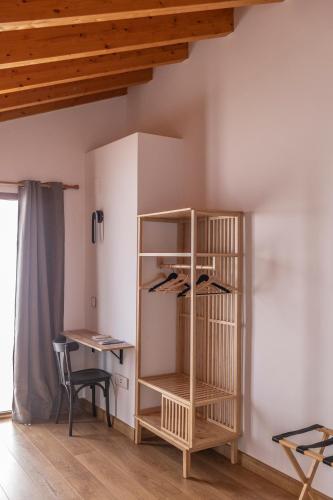 a room with a wooden book shelf and a desk at ANJ Alojamientos in Guadalupe