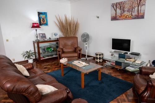 a living room with a leather couch and a coffee table at TMO Residence 2 in Ponta Delgada