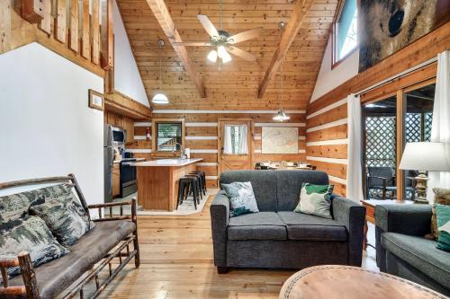 a living room with a couch and a table at Wolf Run Gatlinburg Location Log Cabin Hot Tub in Gatlinburg