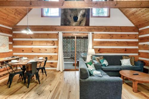 a living room with a couch and a table at Wolf Run Gatlinburg Location Log Cabin Hot Tub in Gatlinburg