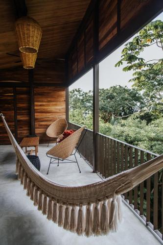 a hammock on the porch of a house at Casa Selva Sayulita in Sayulita