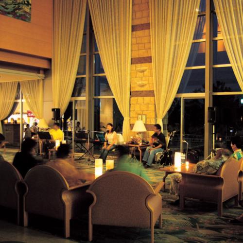 a group of people sitting in a room with curtains at Kyukamura Echizen-Mikuni in Sakai