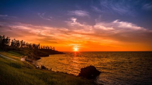 a sunset over a body of water with the sun setting at Kyukamura Echizen-Mikuni in Sakai