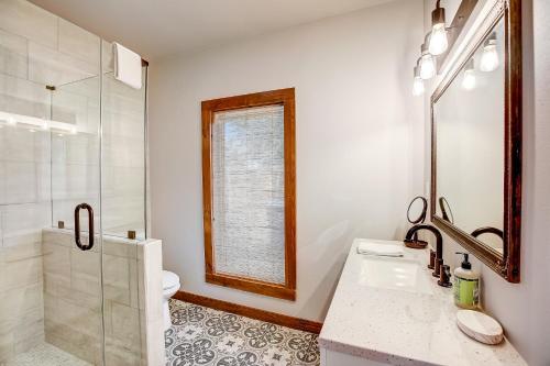 a bathroom with a sink and a toilet and a window at Marble Falls Zen in Marble Falls