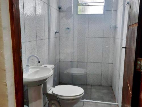 W łazience znajduje się toaleta, umywalka i prysznic. w obiekcie Águas Quentes w mieście Caraguatatuba