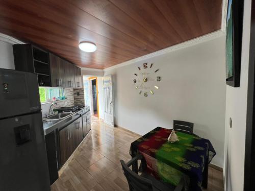 a kitchen with a clock on the wall at Posada Ashanty in Providencia