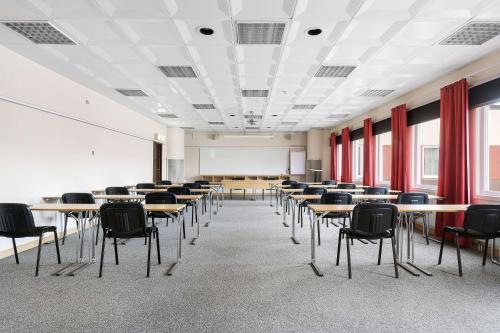 a classroom with tables and chairs in a room at Best Western Nya Star Hotel in Avesta