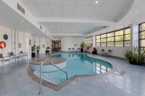 a large swimming pool in a hospital lobby at C Hotel by Carmen's, BW Premier Collection in Hamilton