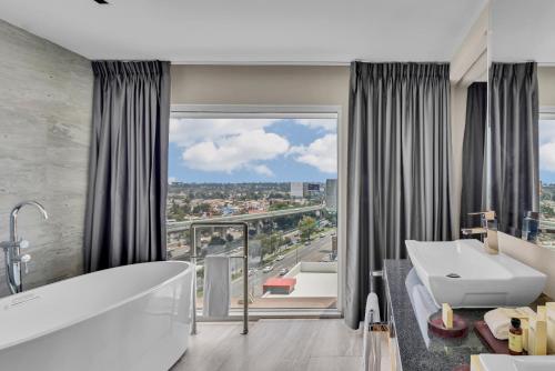 a bathroom with a tub and a large window at Fiesta Americana Ciudad de México Satelite in Mexico City