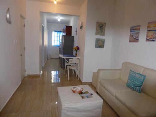 a living room with a couch and a table at CortLang Vacation Rentals, El Pueblito in San Felipe de Puerto Plata