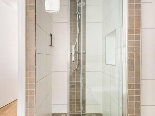 a shower with a glass door in a bathroom at Charming holiday home in Poortugaal with garden in Poortugaal