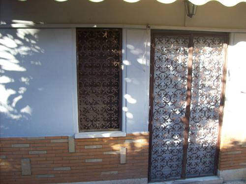 a front door of a house with a wrought iron gate at B&B Rome For You in Rome