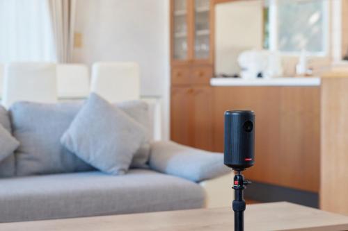 a camera on a tripod in front of a couch at ritomaru house iki ashibe in Iki