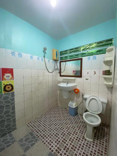 a bathroom with a toilet and a sink at Nan Inn Bungalow in Karon Beach