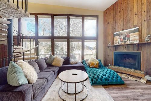 a living room with a couch and a fireplace at Mountainside Oasis in Avon