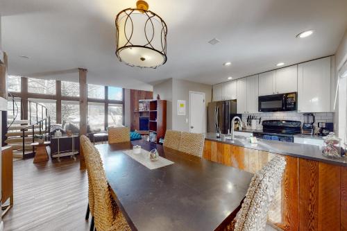 a large kitchen with a long table and chairs at Mountainside Oasis in Avon