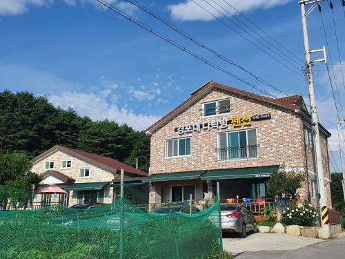 a building with a fence in front of it at Gyeongpodae Darakbang in Gangneung