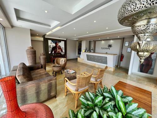 a living room with a couch and chairs and a tv at PlazaMar Pacifico Hotel in Buenaventura