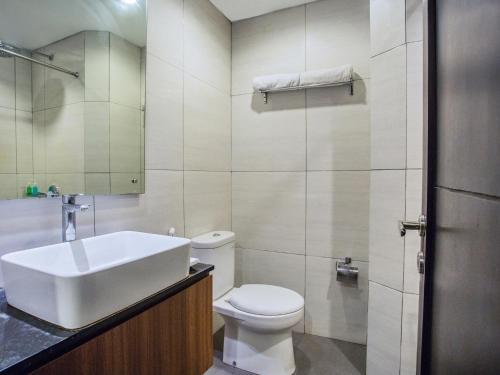 a bathroom with a sink and a toilet at Grand Mirah Boutique Hotel in Denpasar