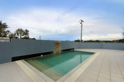 a swimming pool on the side of a house at Beach Break in Bargara