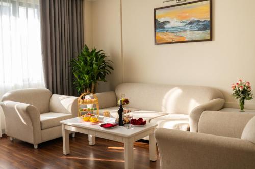 a living room with two couches and a table at Ha Long Dream Hotel in Ha Long