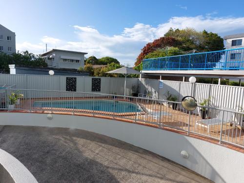 a swimming pool on top of a building at Sandy Shores Holiday Units in Caloundra