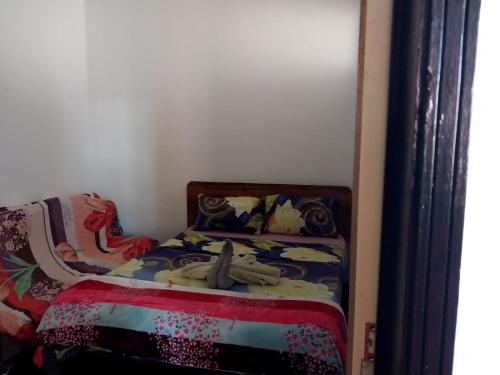 a small bedroom with a bed in a room at Reviva Residence in Blue Bay