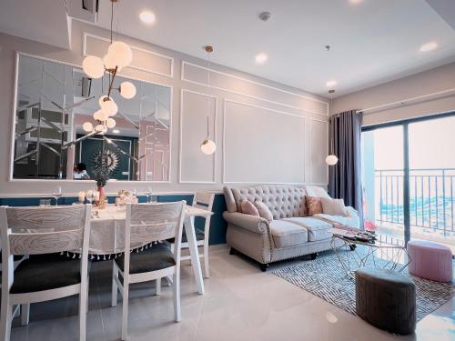 a living room with a table and a couch at Tommy Homes in Soho Residence Central District 1 in Ho Chi Minh City