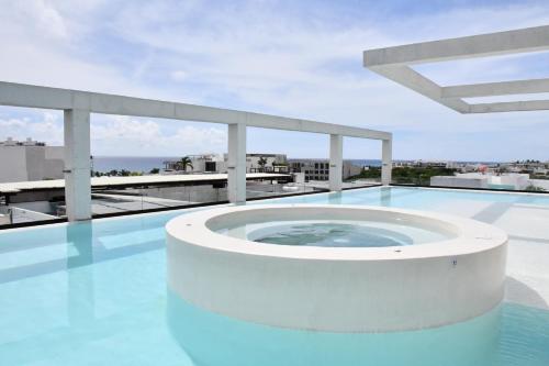 a hot tub on the roof of a building at Ceren Luxury Apartments at Fifth Avenue by Spot Rentals in Playa del Carmen