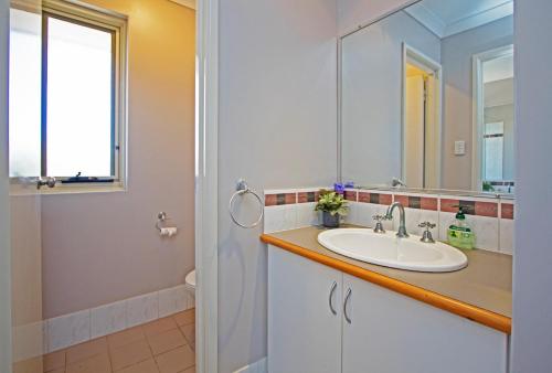 a bathroom with a sink and a mirror at Boronia 4x2 in Jurien Bay